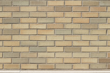 Vintage yellow brick wall background in varying shades yellow, beige, pink and tan