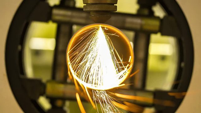 4K: Industrial laser cutter with sparks. Close up. 