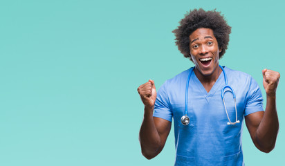 Afro american surgeon doctor man over isolated background celebrating surprised and amazed for...