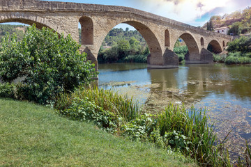 Fototapeta premium Ancient roman bridge across the Arga river in Puente la Reina, near Pamplona, Navarra, Spain