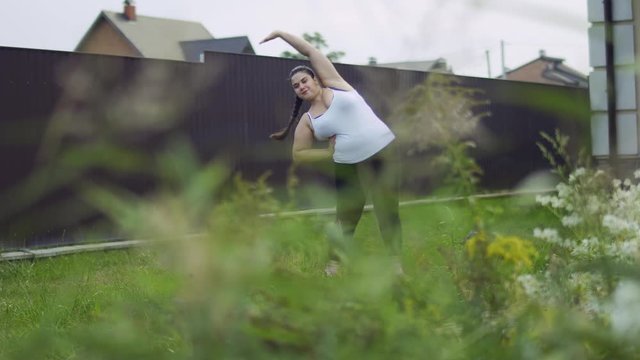 The fat girl is doing exercises