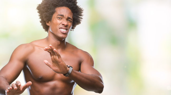 Afro american shirtless man showing nude body over isolated background disgusted expression, displeased and fearful doing disgust face because aversion reaction. With hands raised. Annoying concept.