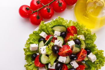 Greek salad on a white acrylic background