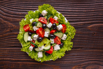 Greek salad on a wooden rustic background