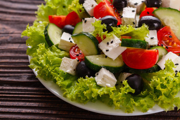 Greek salad on a wooden rustic background