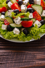 Greek salad on a wooden rustic background