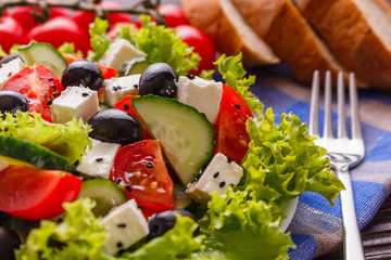 Greek salad on a wooden rustic background