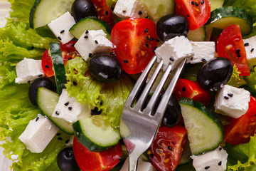 Greek salad on a wooden rustic background