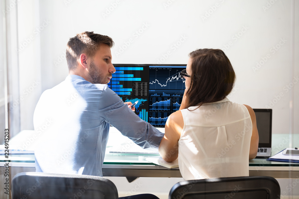 Poster two stock market brokers discussing graphs on computer