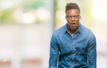 Young african american man over isolated background afraid and shocked with surprise expression, fear and excited face.