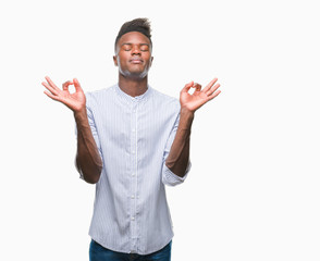 Fototapeta premium Young african american man over isolated background relax and smiling with eyes closed doing meditation gesture with fingers. Yoga concept.