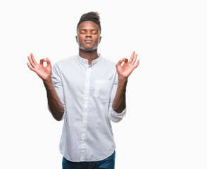 Young african american man over isolated background relax and smiling with eyes closed doing meditation gesture with fingers. Yoga concept.