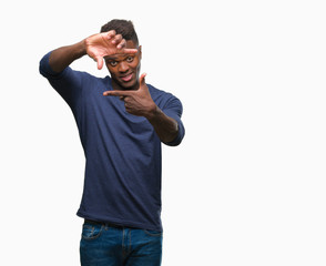 Fototapeta premium Young african american man over isolated background smiling making frame with hands and fingers with happy face. Creativity and photography concept.