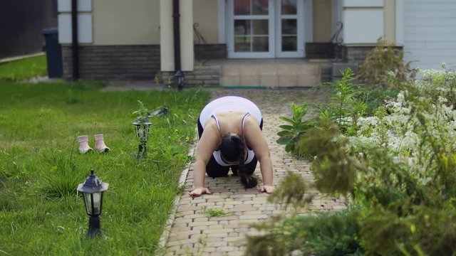 The fat girl is doing exercises