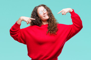 Beautiful brunette curly hair young girl wearing glasses and winter sweater over isolated...