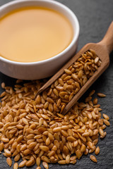 seeds of golden flax on a dark stone background