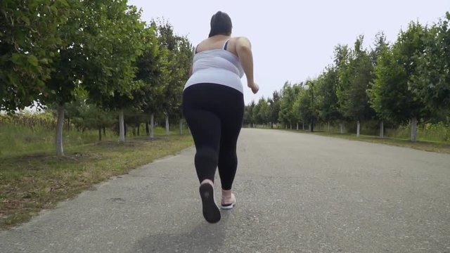 Fat girl runs along the road
