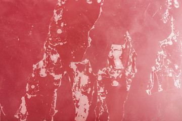 Old faded red color on a car hood