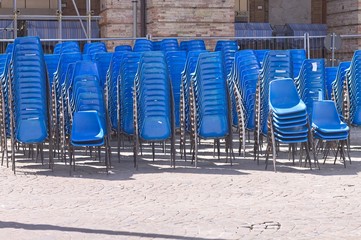A set of blue chairs on the street (Marche, Italy, Europe)