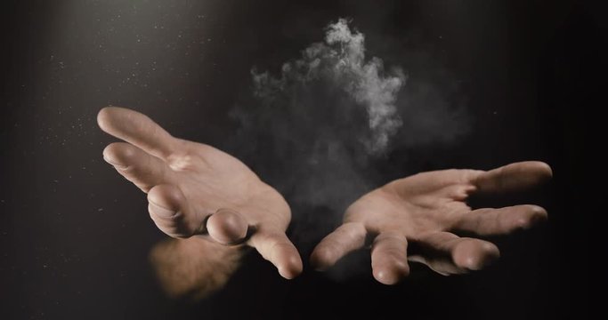 Modern magician conjuring smoke from his hands, Magic Trick Concept