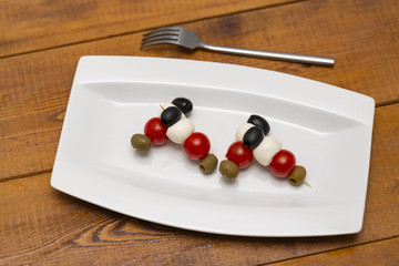 Naklejka na ściany i meble Italian appetizer, olives with mozzarella and tomatoes