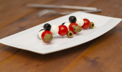 Naklejka na ściany i meble Italian appetizer, olives with mozzarella and tomatoes