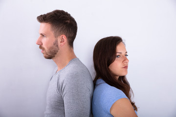 Unhappy Couple Standing Back To Back