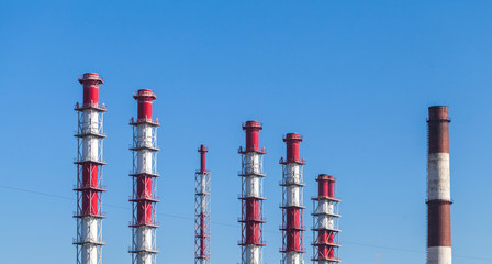 Striped red white industrial chimneys