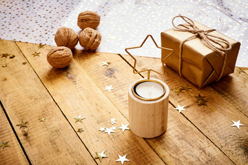beautiful Christmas Eve background on an old wooden table with gifts and nuts decorations