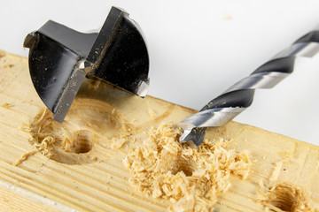 Drilling holes with a wood drill in a workshop. Joinery works performed with the use of cutting tools.