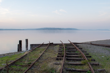 Fototapeta na wymiar Railroad tracks into the ocean