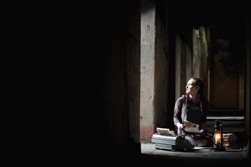 A girl with old books in the old house