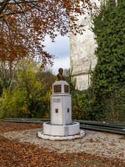 Autumn picture of the bust monument of Jean-Hubert Cavens, a maecenas and philanthropist from the 19th century in Malmedy, Belgium