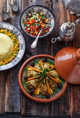 Close view of chicken tajine with lemon and olives