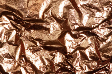 Gold bright shiny texture of a crumpled sheet.