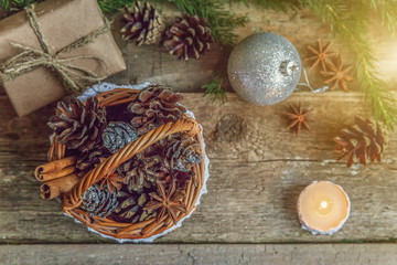 Christmas New Year composition with gift box fir branch basket pine cones candle balls on old shabby rustic wooden background. Xmas holiday december decoration to Russian tradition. Copy space