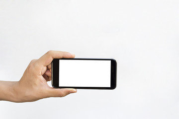 Man hand holding horizontal the black smartphone with blank screen, isolated on white background.