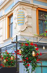 View of historic building of the third Riga society of mutual credit and hanging flowers with...