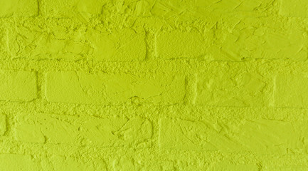 Modern neon yellow stone brick wall with big bricks close up background pattern