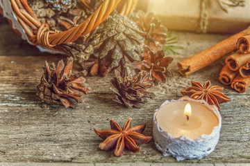 Fototapeta na wymiar Christmas New Year composition with gift box fir branch basket pine cones candle on old shabby rustic wooden background. Xmas holiday december decoration to Russian tradition. Flat lay, copy space
