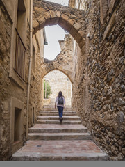 Fototapeta na wymiar Woman walking in medieval village