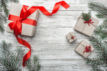 Upper, top view, of some, four, Christmas present on a wooden rustic background, with space for text writing.