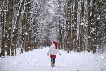 A winter fairy tale, a young mother and her daughter ride a sled