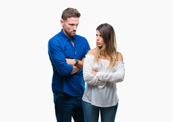 Young couple in love over isolated background skeptic and nervous, disapproving expression on face with crossed arms. Negative person.