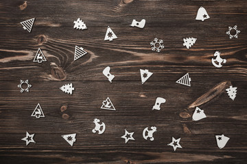 Fototapeta premium View from above of handmade tree toys on wooden background, greeting card