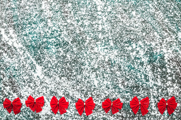Red bows om gray, marble, stone background, view from top, above, flat, Xmas greeting card with space for text.