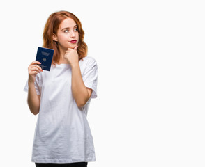 Fototapeta premium Young beautiful woman holding passport of germany over isolated background serious face thinking about question, very confused idea