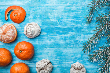 Wallpaper of azure wood, open, sea. mandarins, green fir branch. Xmas and New Year's Message. Sweets for holidays. Xmas and Happy New Year composition. Flat lay, top view