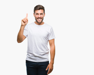 Young handsome man over isolated background showing and pointing up with finger number one while smiling confident and happy.