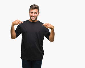 Fototapeta premium Young handsome man over isolated background looking confident with smile on face, pointing oneself with fingers proud and happy.